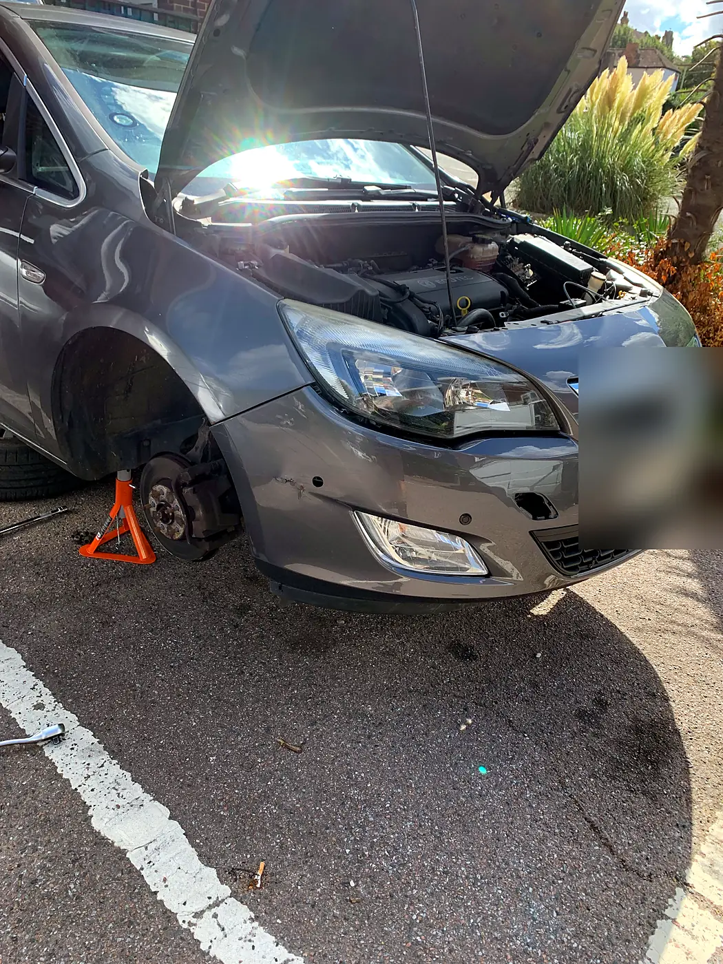 Vauxhall Astra being repaired at the roadside by a mobile mechanic