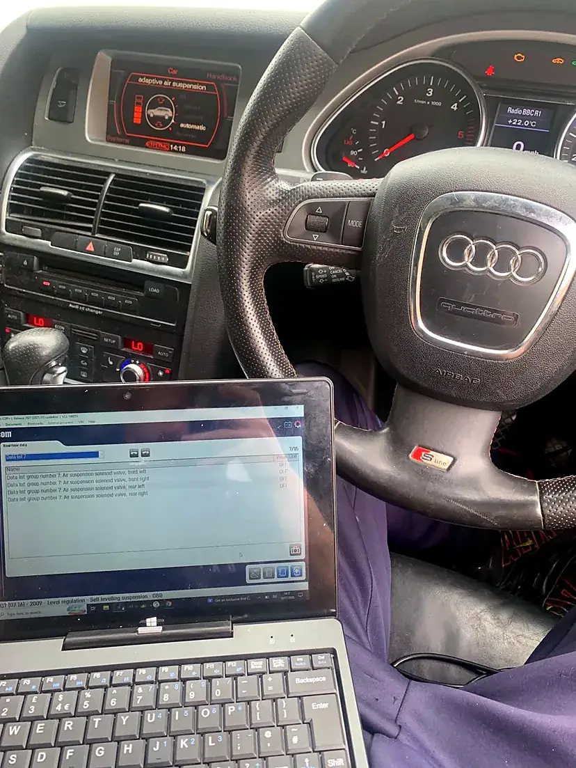 Laptop running car diagnostic software connected to a vehicle