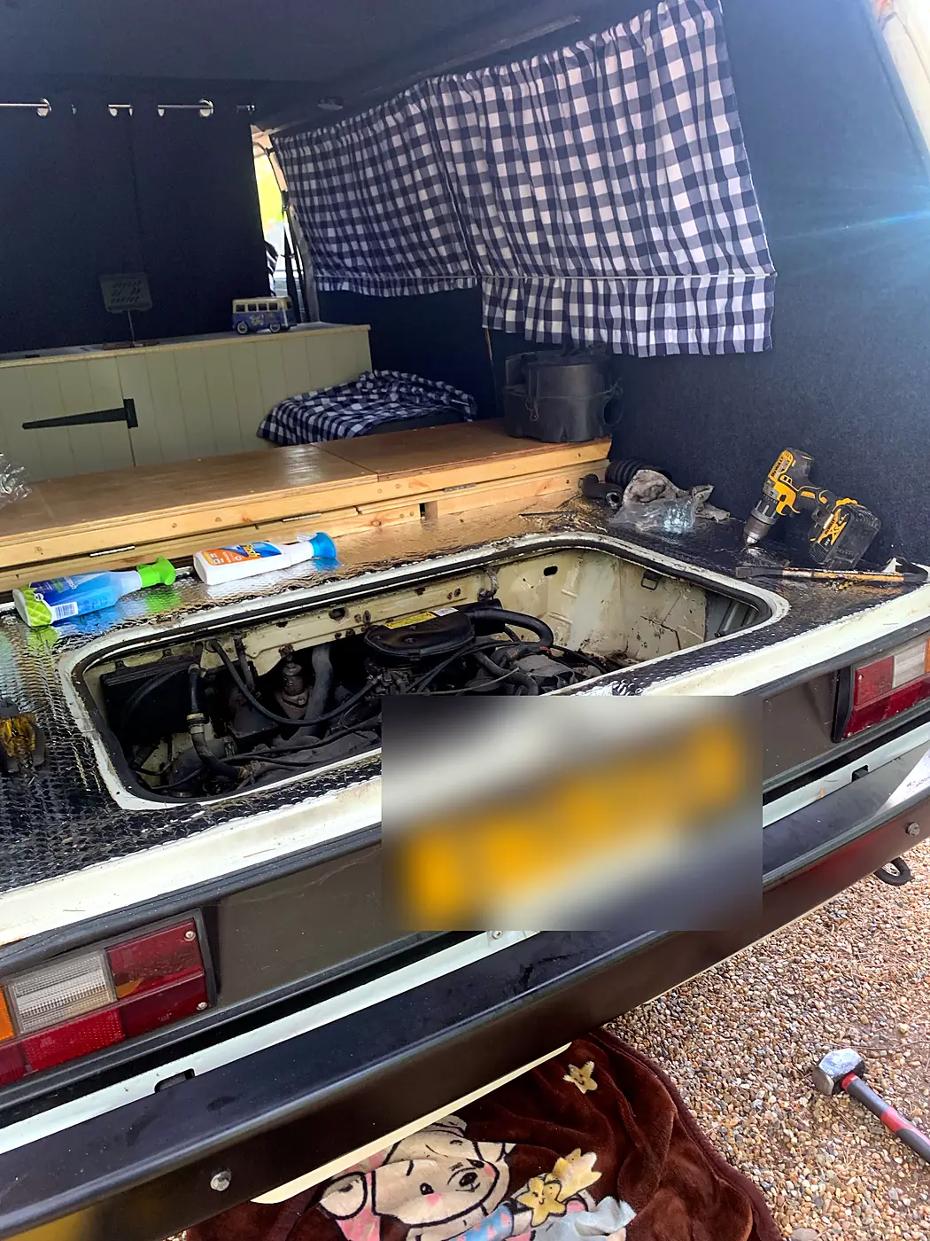 Rear-engined classic camper repaired on the drive.