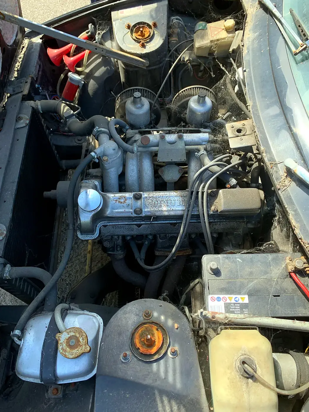 Carburettor and ignition work on a classic Triumph engine.