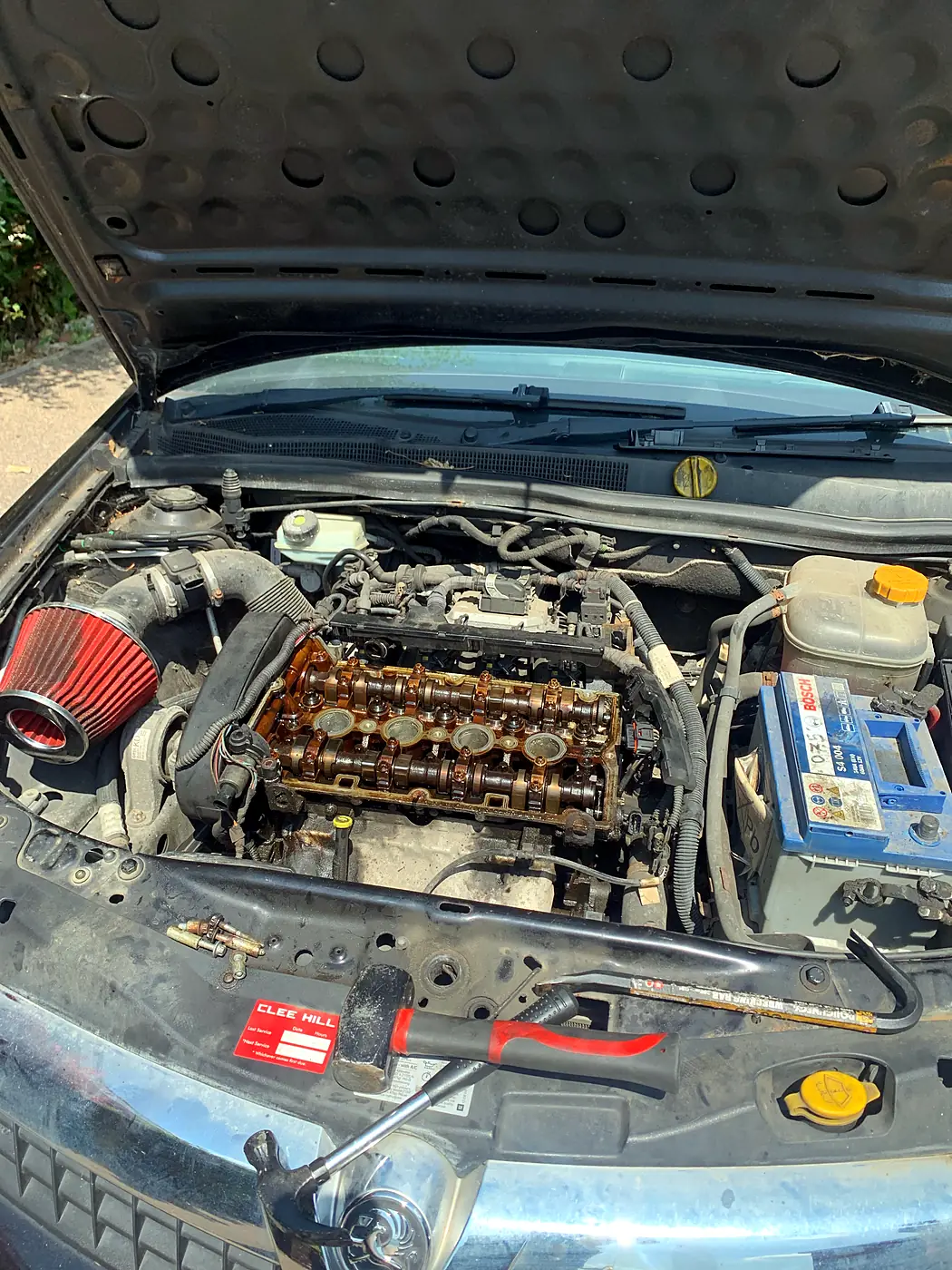 Engine with rocker cover removed showing camshafts during an engine repair