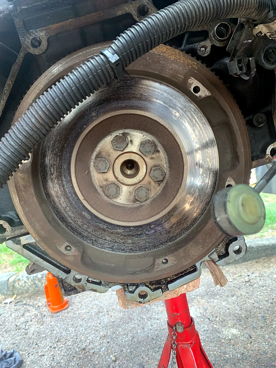 Flywheel exposed with the gearbox removed during a driveway clutch replacement