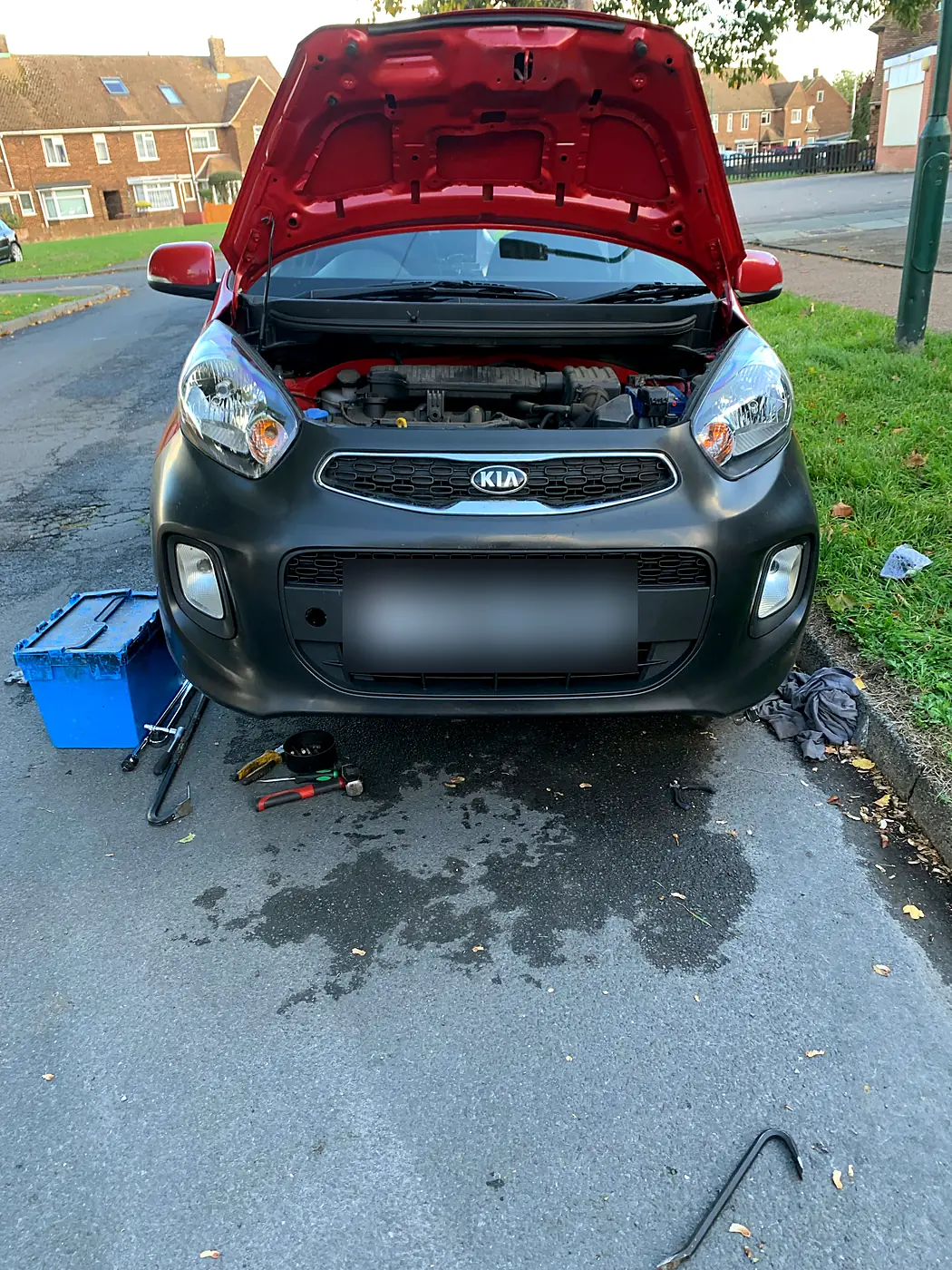 Kia Picanto with a new black front bumper fitted at the roadside