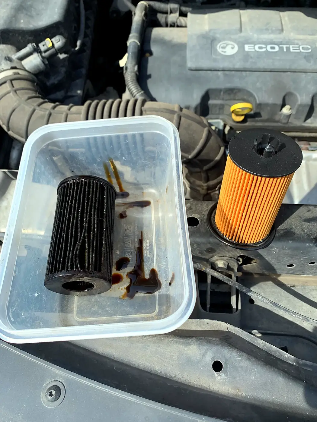 Old and new oil filter during a mobile service.