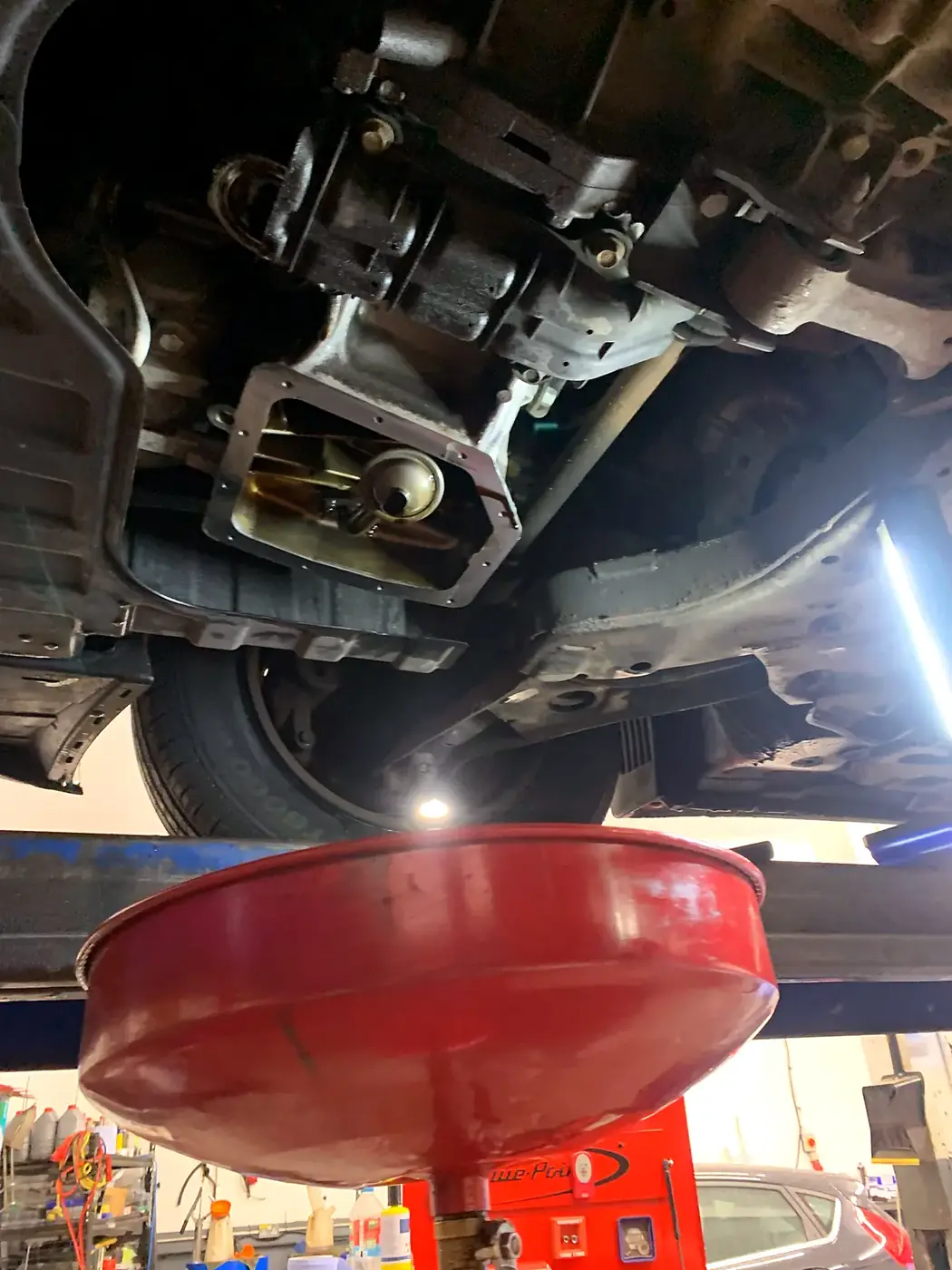 Old engine oil drained during a service.